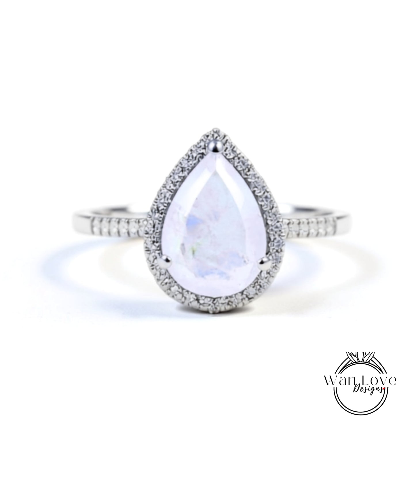 A diamond ring with a large, clear gemstone in the center, surrounded by a halo of smaller diamonds.