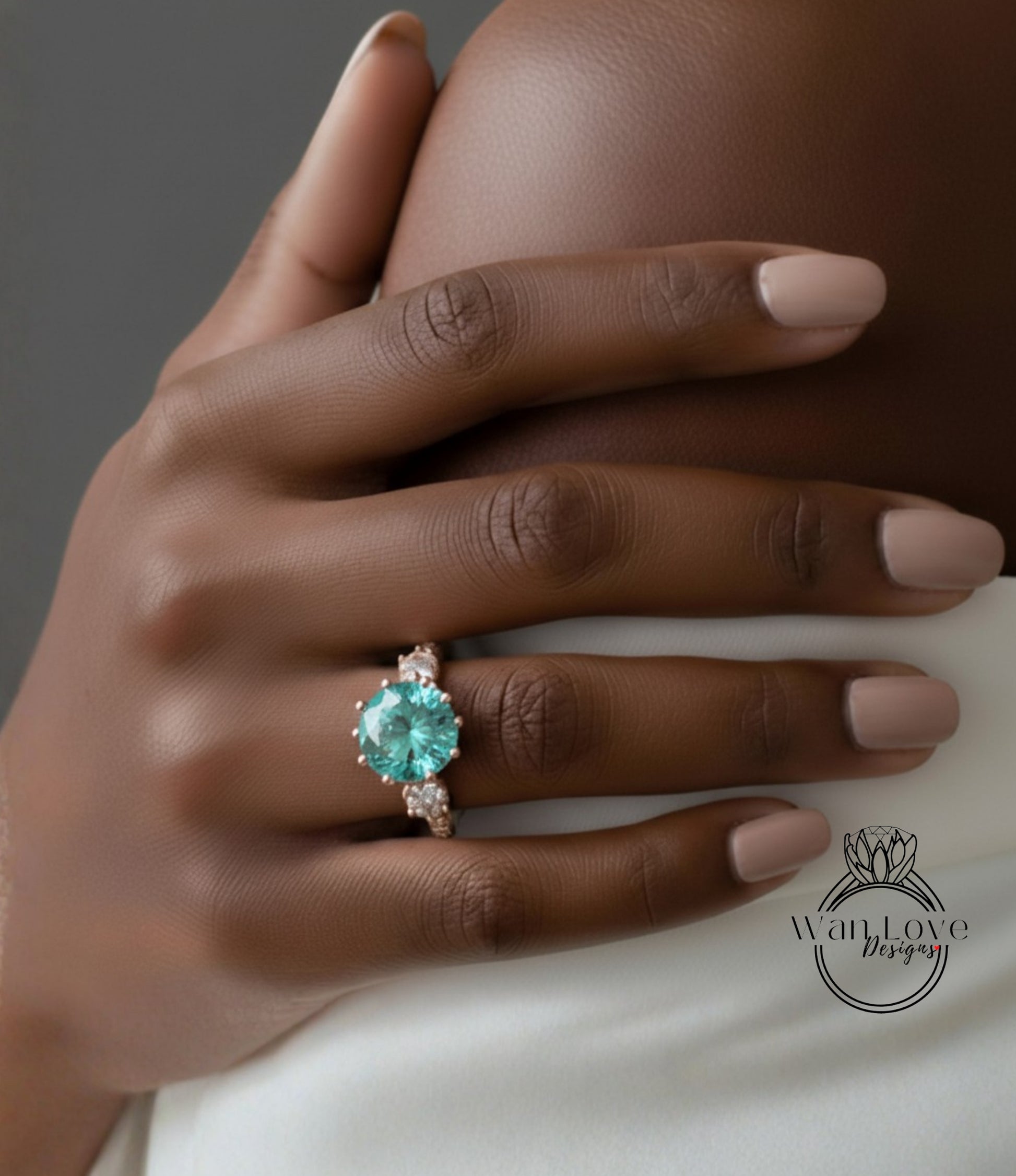 A close-up of a hand wearing a large, turquoise-colored gemstone ring with a gold band.