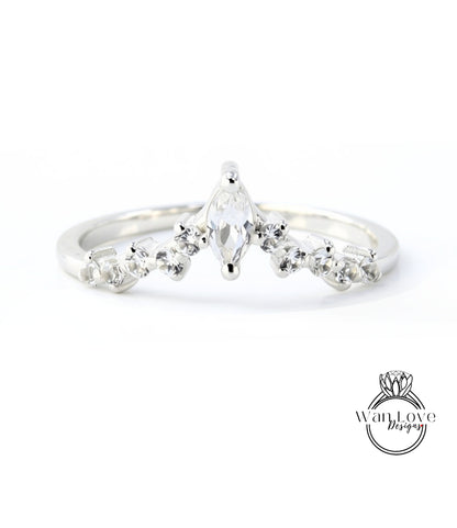 A silver ring with a large central diamond surrounded by smaller diamonds, set in a band.