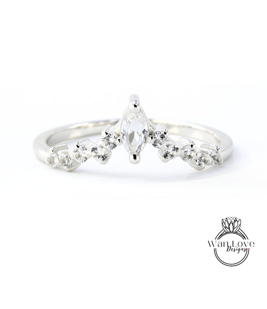 A silver ring with a large central diamond surrounded by smaller diamonds, set in a band.