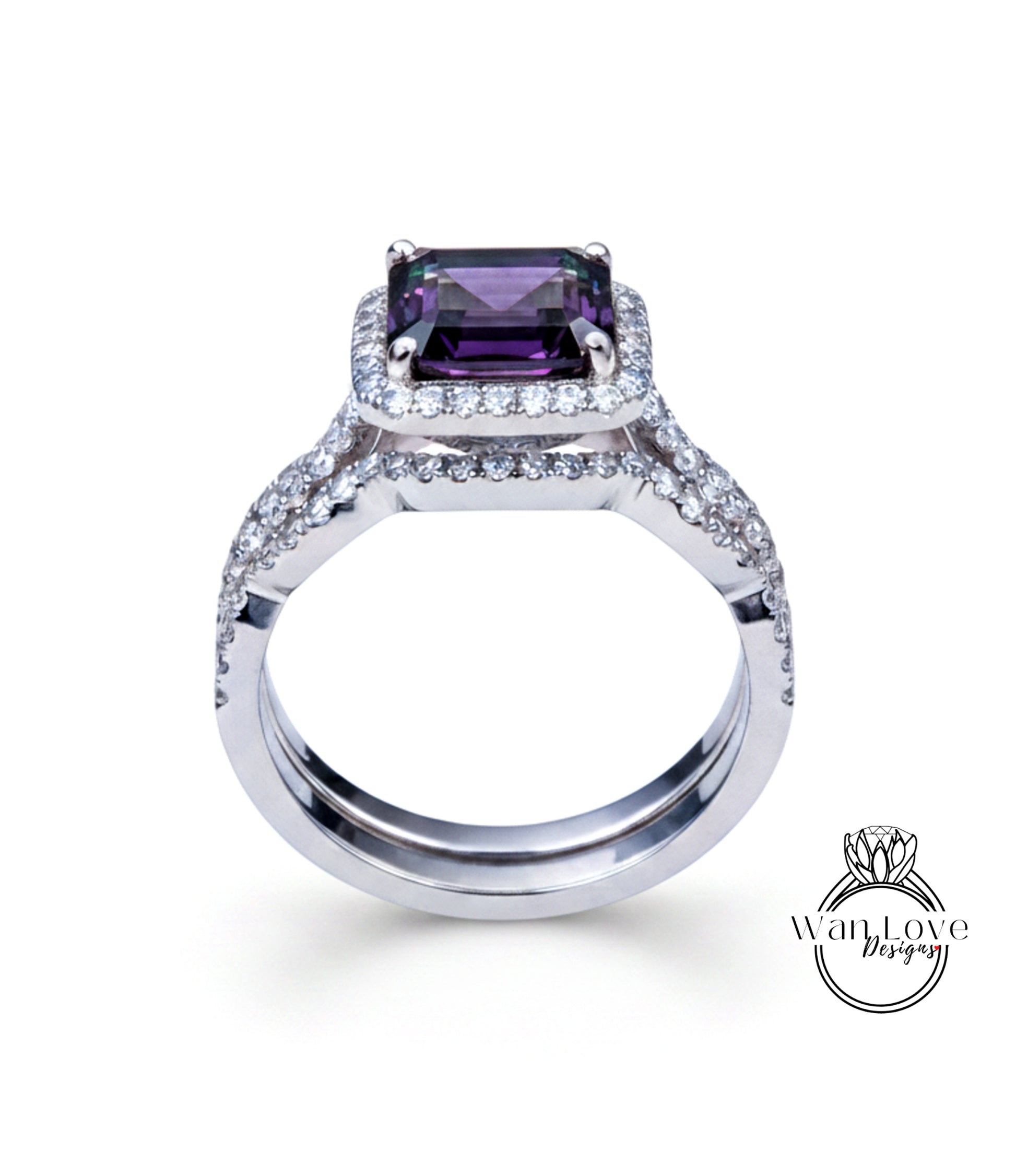 A silver ring with a large purple gemstone, likely a diamond, set in the center.