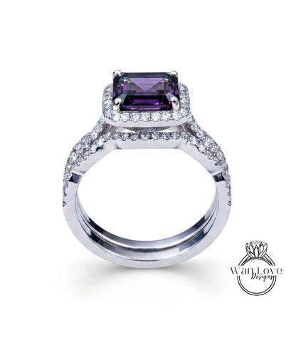 A silver ring with a large purple gemstone, likely a diamond, set in the center.
