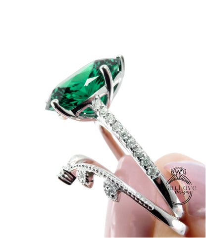 A close-up image of a large, green gemstone set in a silver ring with a decorative element.
