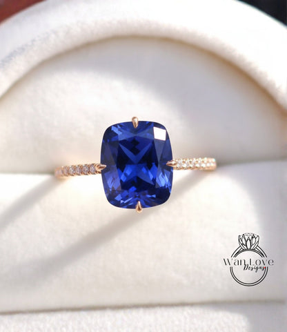 A close-up image of a gold ring with a large blue gemstone, likely a sapphire, set in the center.