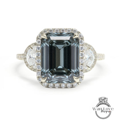 A large, dark blue diamond ring with a halo of smaller diamonds around the center stone.
