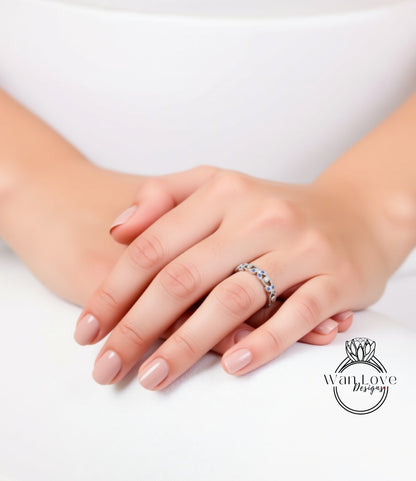 A close-up image of a person's hands wearing a ring on the ring finger.