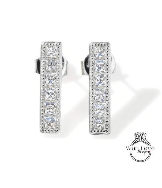 A pair of elegant silver earrings with a row of small diamonds along the length of the bars.