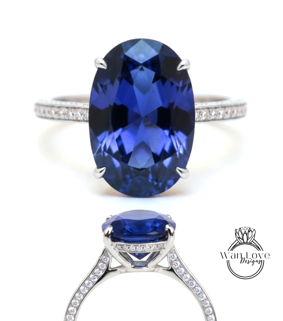 A stunning blue sapphire engagement ring with a large oval-shaped gemstone set in a silver band adorned with small diamonds.