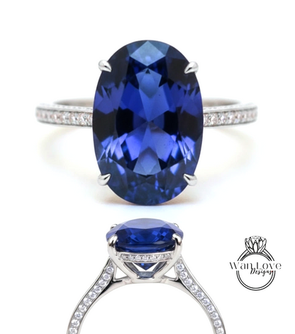 A stunning blue sapphire engagement ring with a large oval-shaped gemstone set in a silver band adorned with small diamonds.