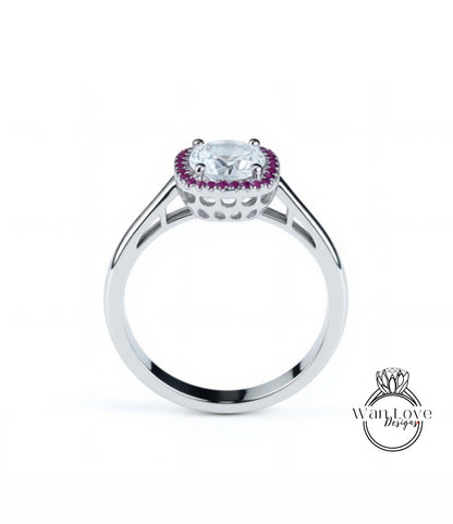 A silver ring with a large central gemstone surrounded by a halo of smaller purple stones.