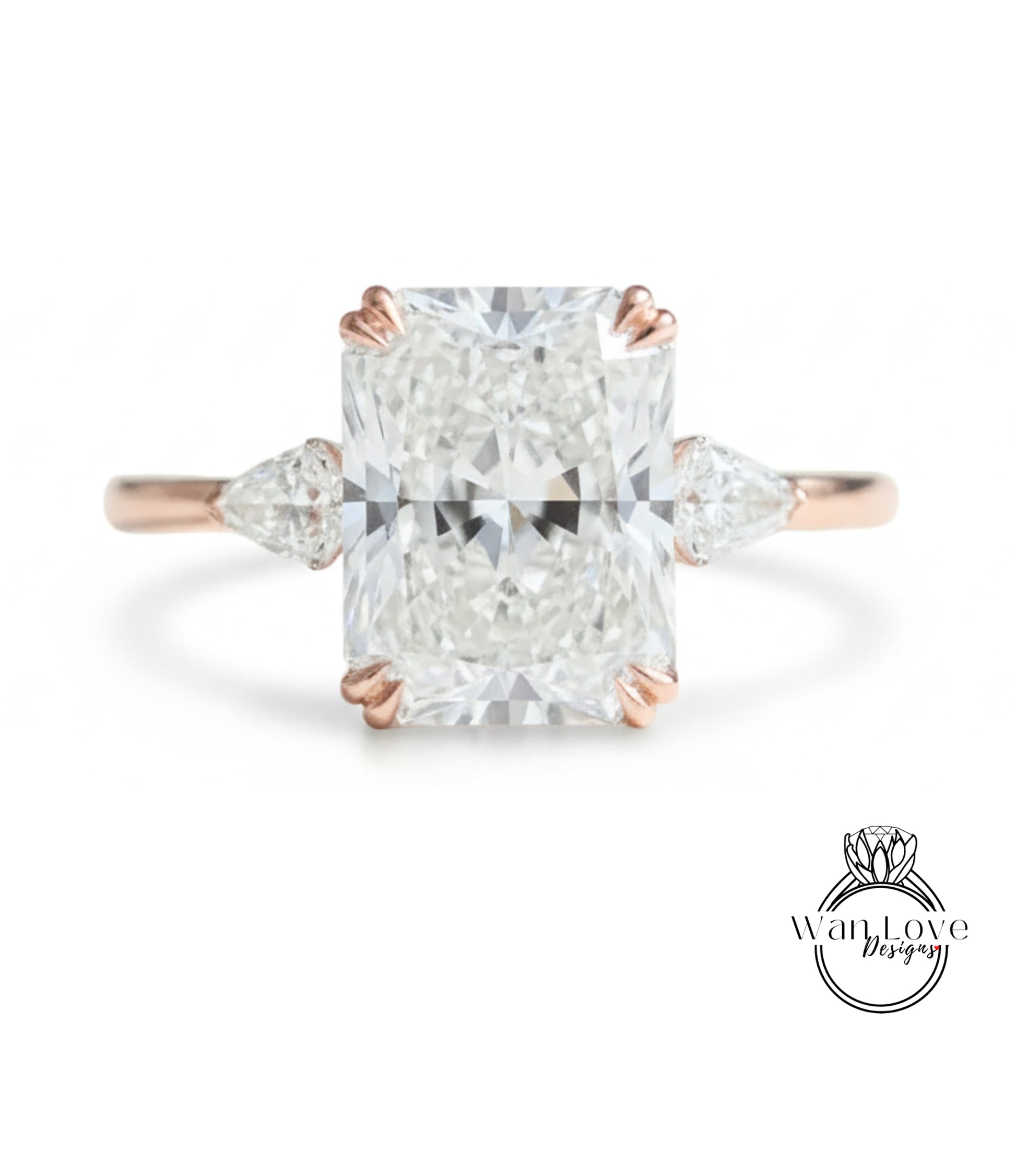 A large, clear diamond engagement ring with a prominent central diamond surrounded by smaller diamonds on either side.