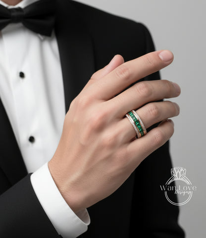 A close-up of a person's hand wearing a ring with a green gemstone band.
