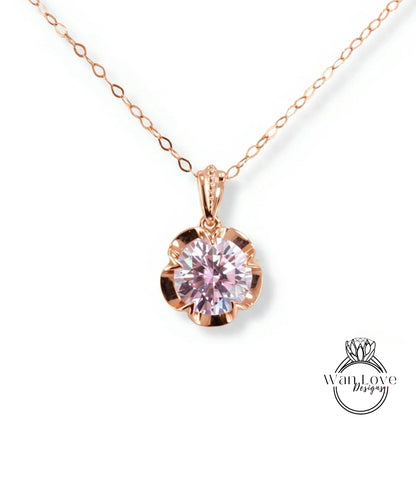 A delicate rose gold necklace with a large, round pink gemstone pendant.