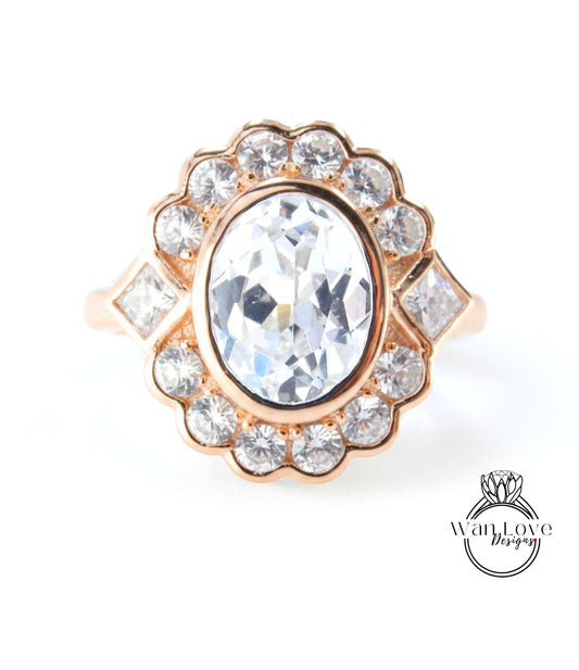 A gold ring with a large oval-shaped gemstone at the center, surrounded by smaller diamonds.