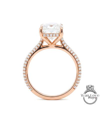 A close-up of a rose gold engagement ring with a large, clear gemstone set in the center.