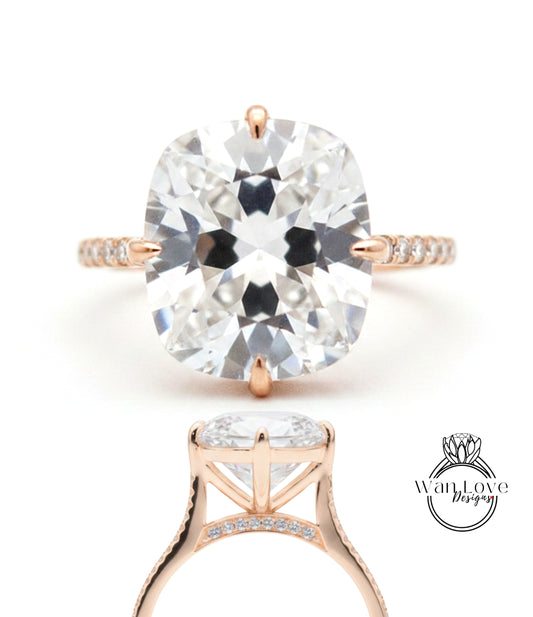 A large, clear diamond engagement ring with a gold band and a prominent central diamond.