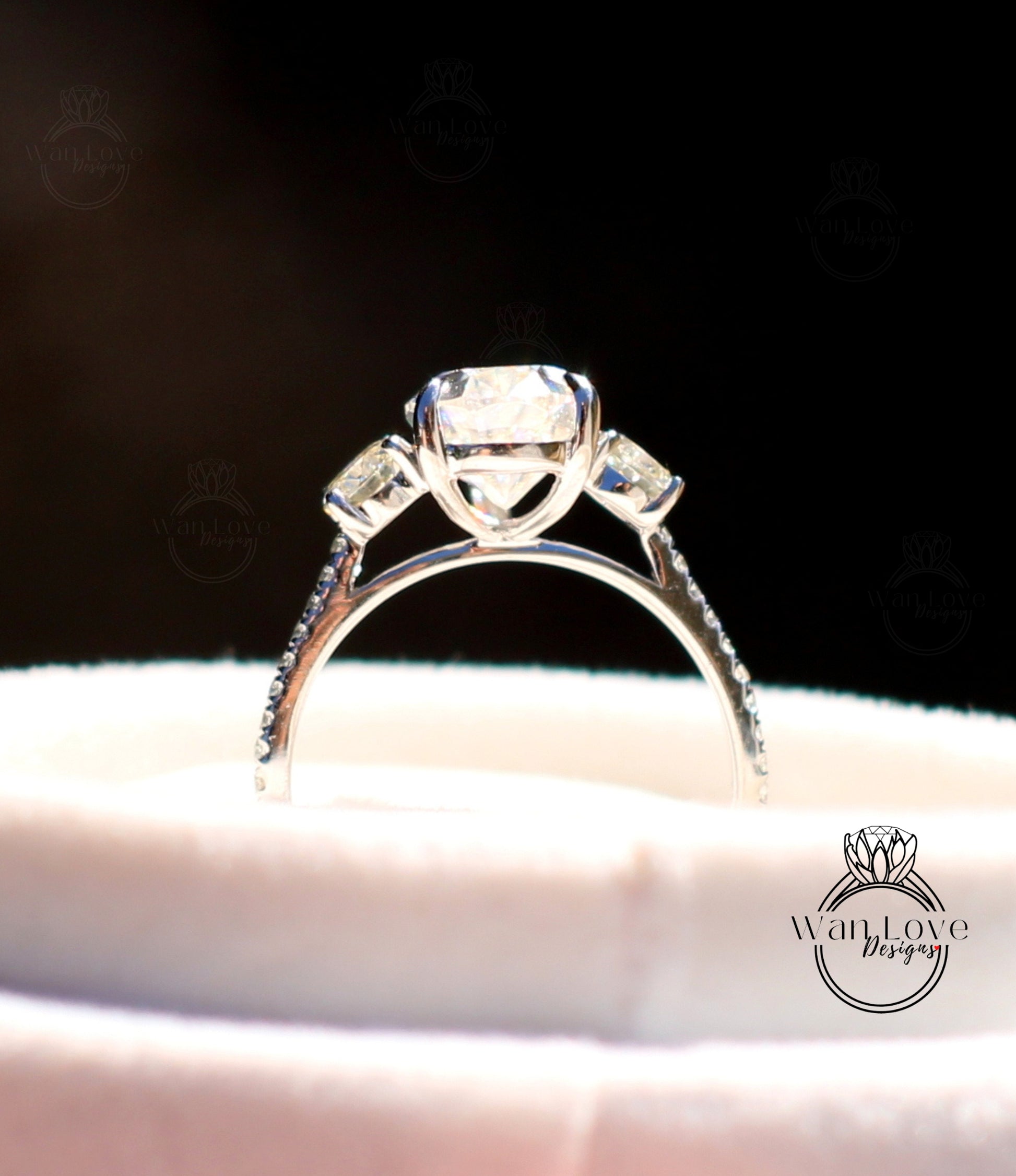 a close up of a diamond ring on a white cloth