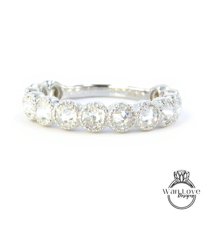 A silver ring with a row of round diamonds set in the center.