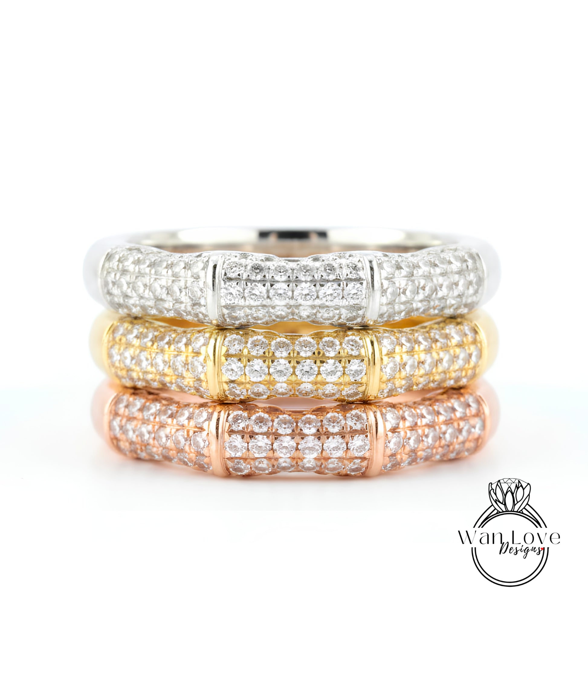A close-up image of a ring with three distinct layers of diamond-encrusted bands, showcasing the intricate design and craftsmanship of the jewelry piece.