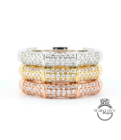 A close-up image of a ring with three distinct layers of diamond-encrusted bands, showcasing the intricate design and craftsmanship of the jewelry piece.