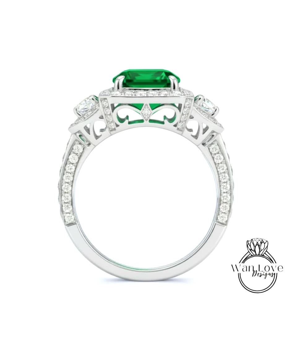 A silver ring with a large green gemstone, surrounded by smaller diamonds.