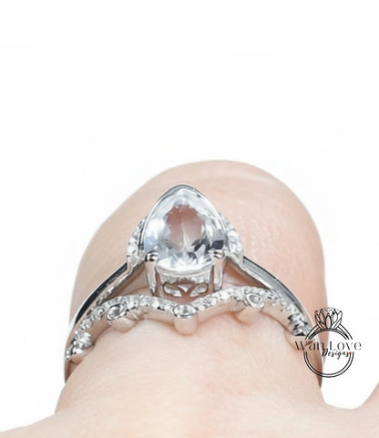 A close-up view of a diamond engagement ring on a person's finger, showcasing the intricate design and sparkling gemstone.