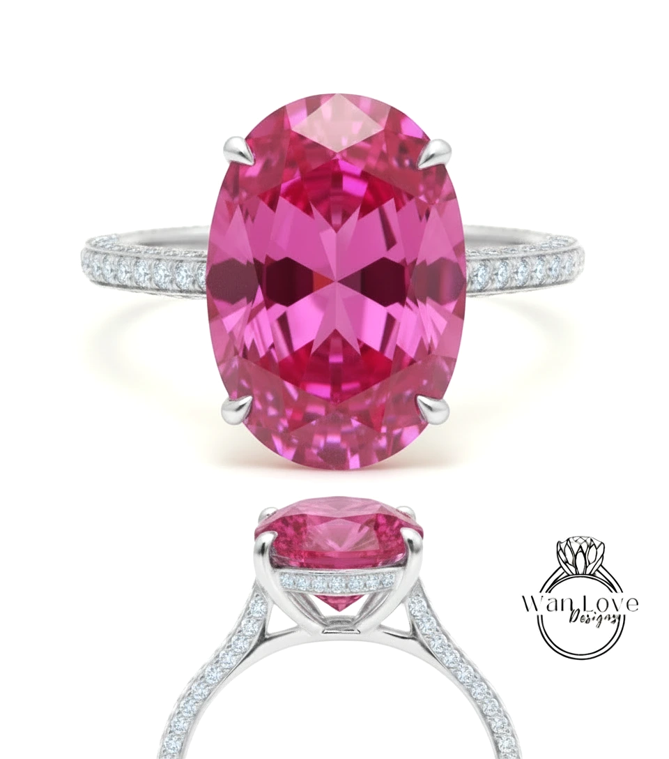 A large oval-shaped pink gemstone set in a silver ring with a halo of smaller diamonds around the edge.