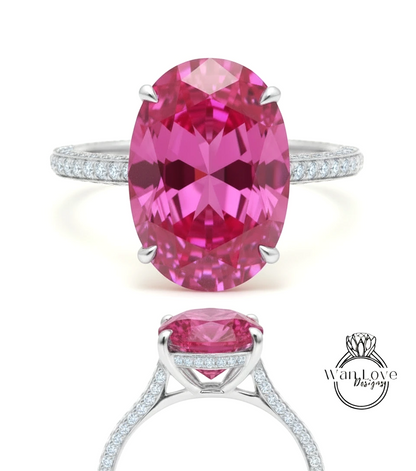 A large oval-shaped pink gemstone set in a silver ring with a halo of smaller diamonds around the edge.