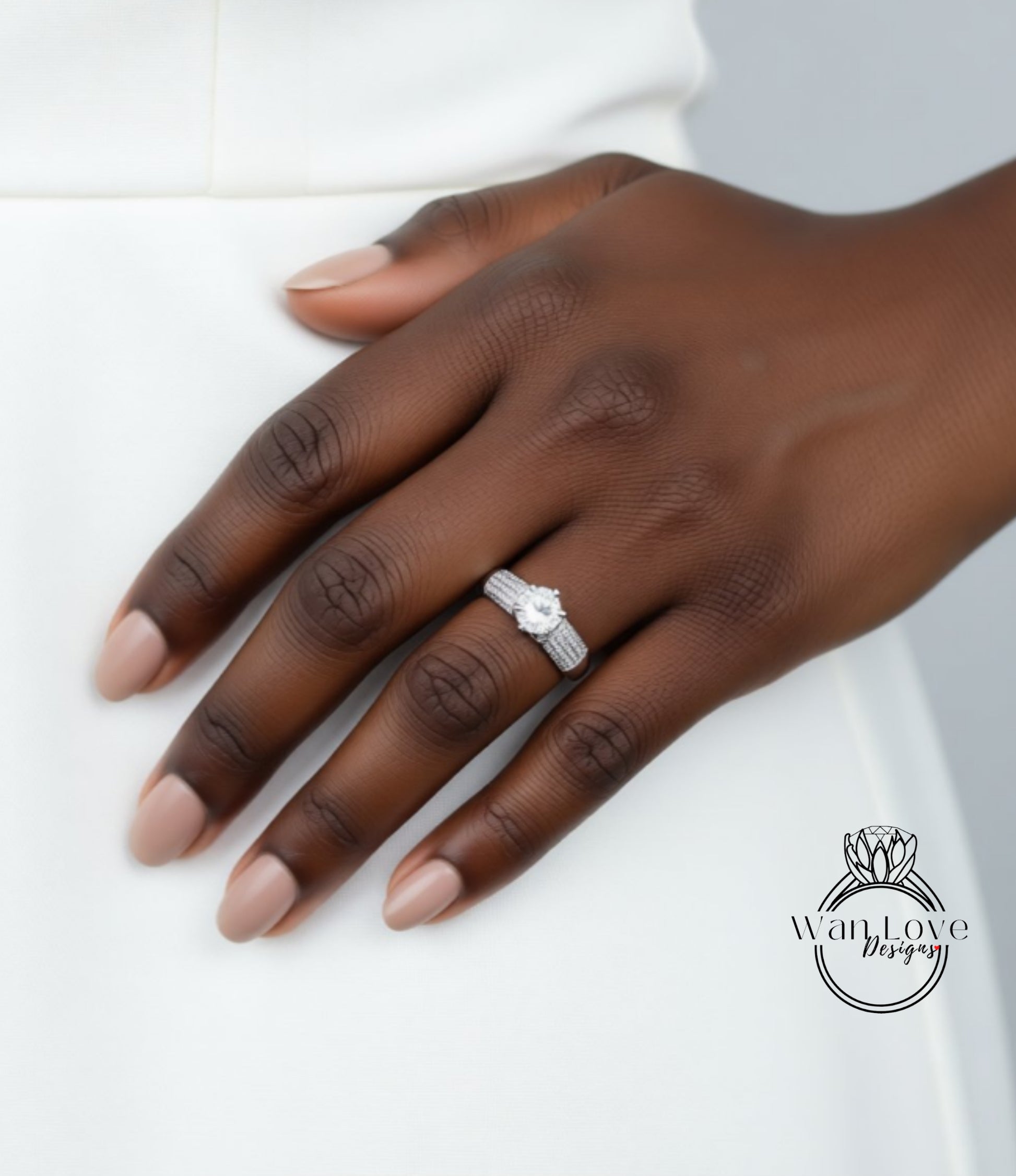 A close-up of a hand wearing a diamond engagement ring.