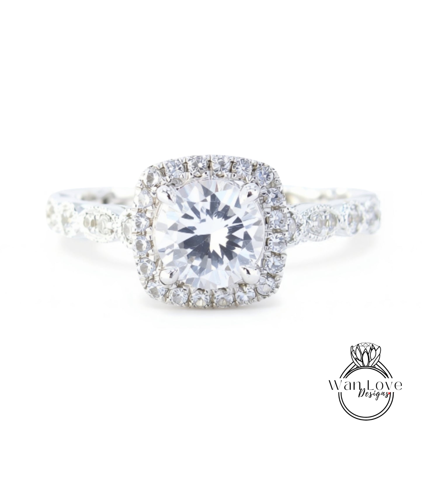 A close-up view of a diamond engagement ring with a large central diamond surrounded by smaller diamonds set in a halo of smaller diamonds.
