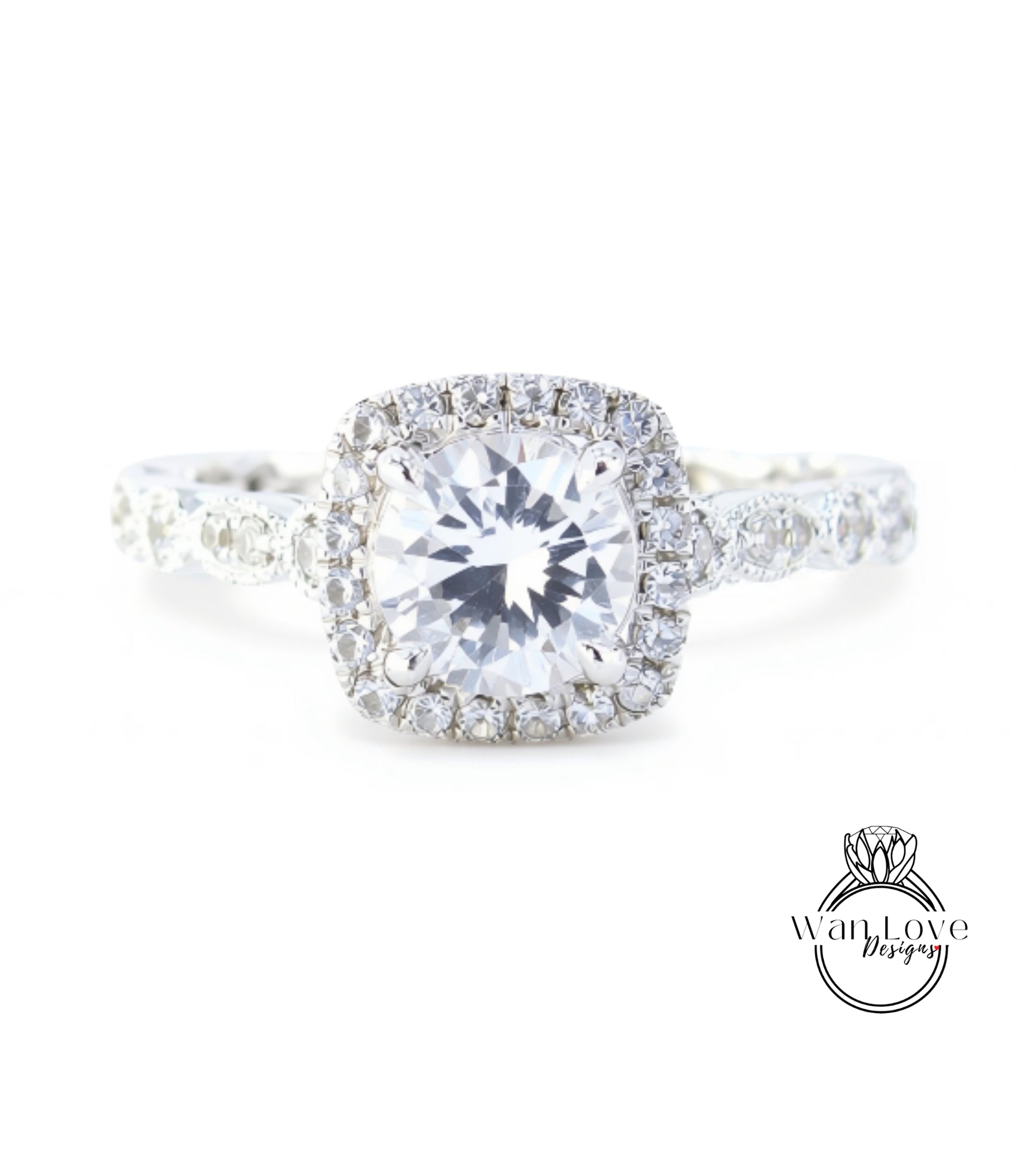A close-up view of a diamond engagement ring with a large central diamond surrounded by smaller diamonds set in a halo of smaller diamonds.