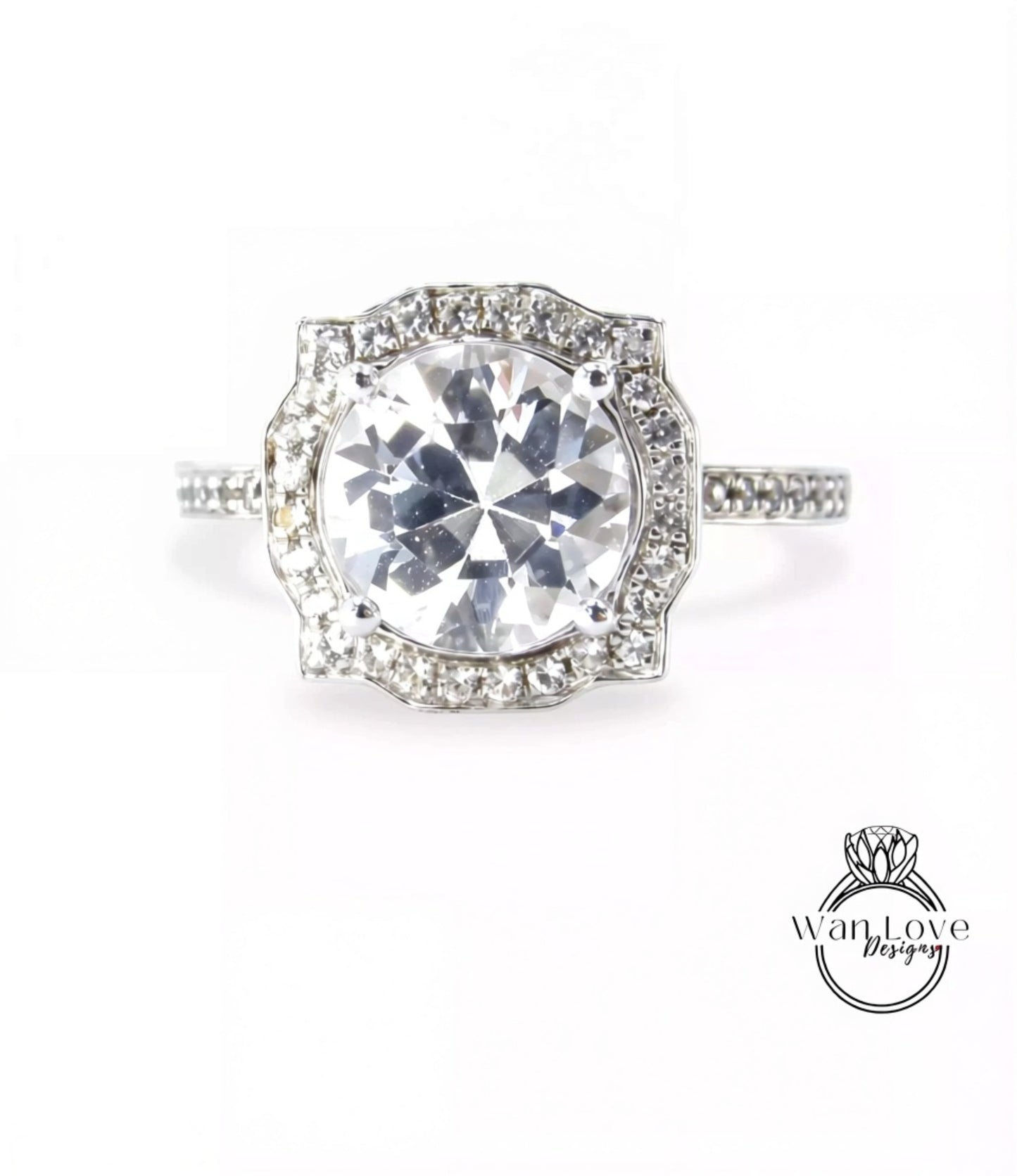 A stunning diamond engagement ring with a large central diamond surrounded by smaller diamonds set in a halo of smaller diamonds.