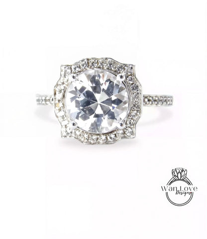 A stunning diamond engagement ring with a large central diamond surrounded by smaller diamonds set in a halo of smaller diamonds.