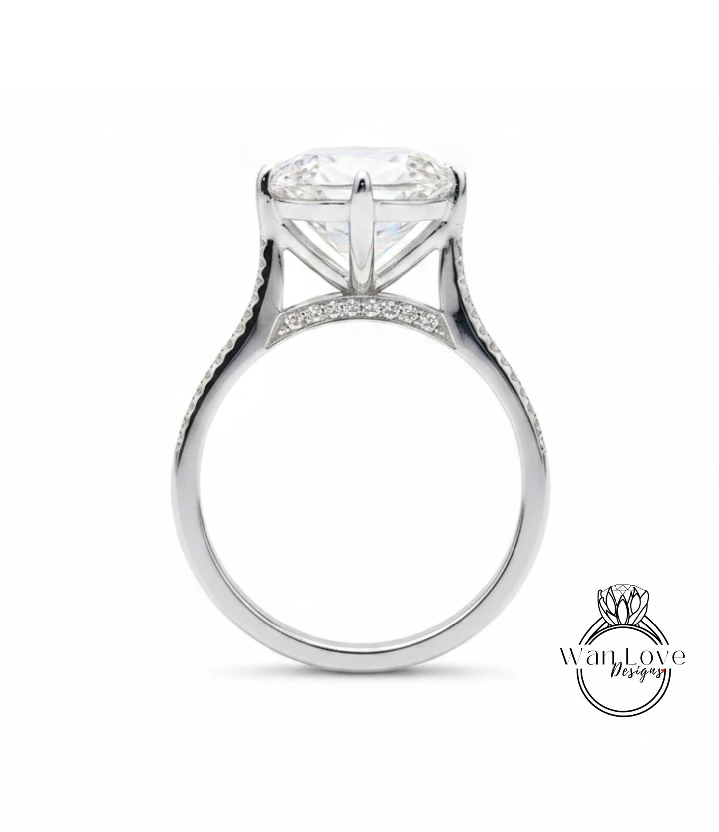 A large, elegant engagement ring with a large central diamond and a delicate band adorned with small diamonds.