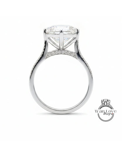 A large, elegant engagement ring with a large central diamond and a delicate band adorned with small diamonds.