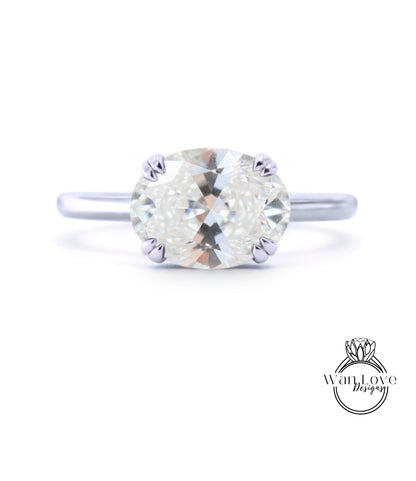 A close-up view of a diamond engagement ring with a large, round brilliant cut diamond set in a silver band.