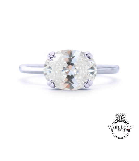 A close-up view of a diamond engagement ring with a large, round brilliant cut diamond set in a silver band.