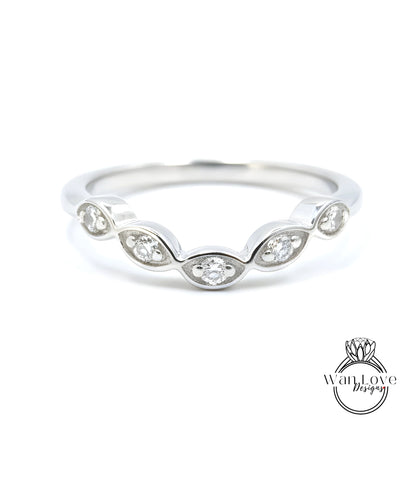 A silver ring with a row of small diamonds set in the center.