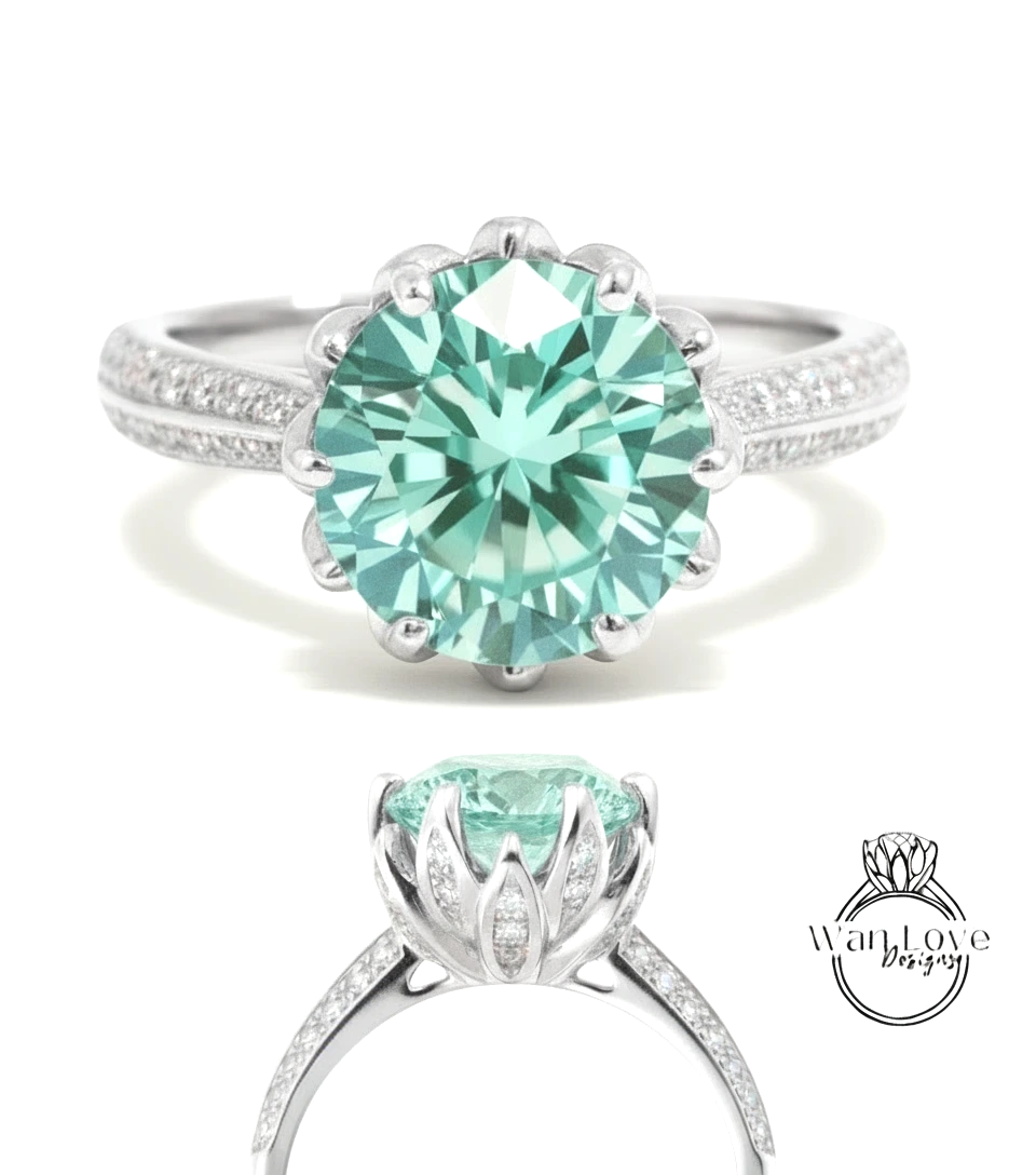 A stunning turquoise diamond engagement ring with a large central gemstone surrounded by smaller diamonds set in a silver band.
