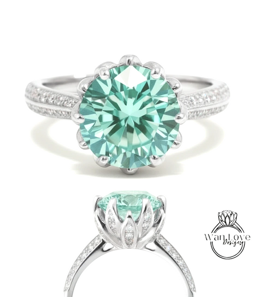 A stunning turquoise diamond engagement ring with a large central gemstone surrounded by smaller diamonds set in a silver band.