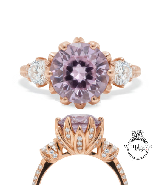 a beautiful engagement ring with a large purple gemstone set in a rose gold band. The ring is adorned with smaller diamonds and has a delicate floral design around the gemstone.