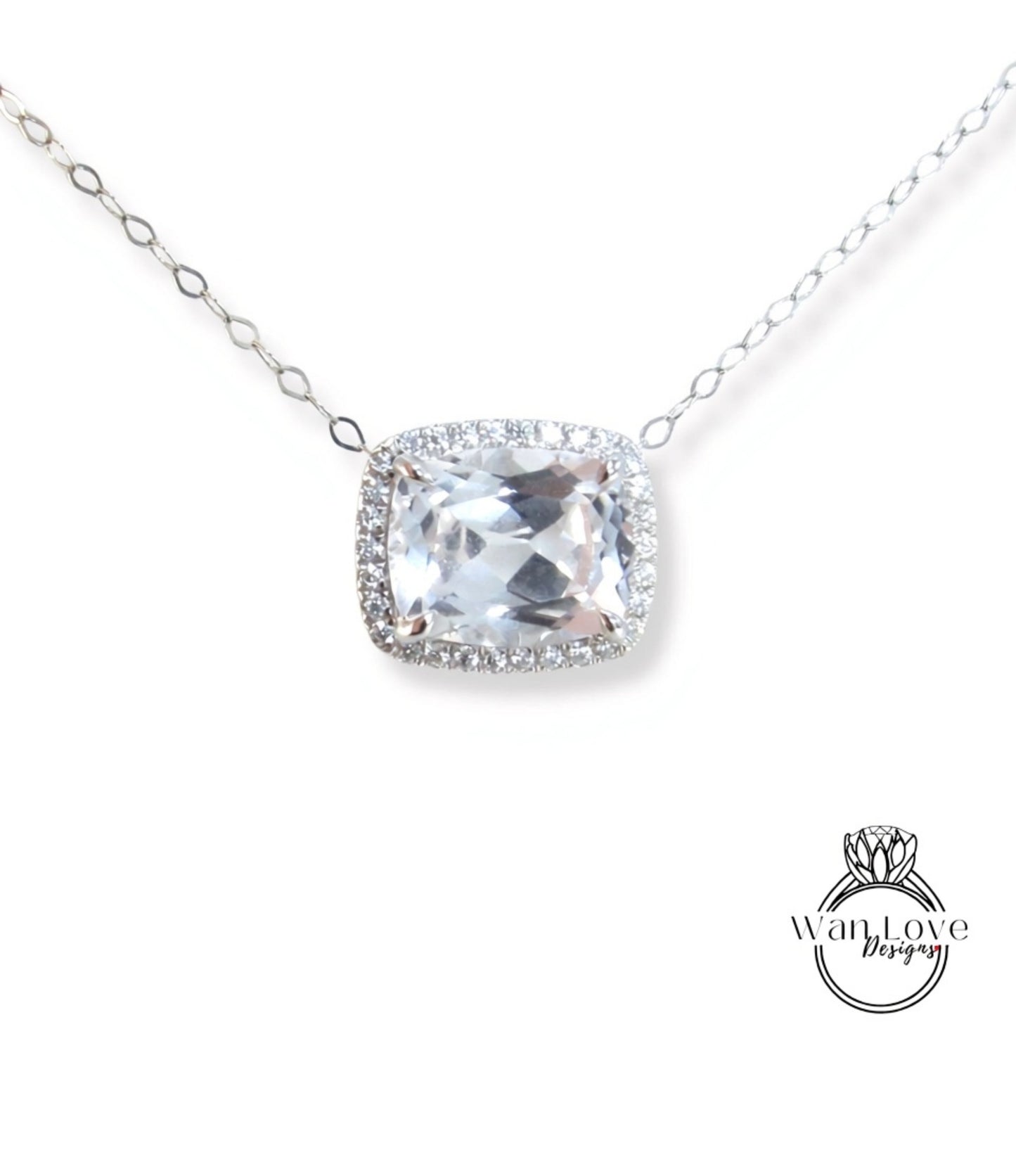 A necklace with a large, clear gemstone pendant, surrounded by a halo of smaller diamonds.