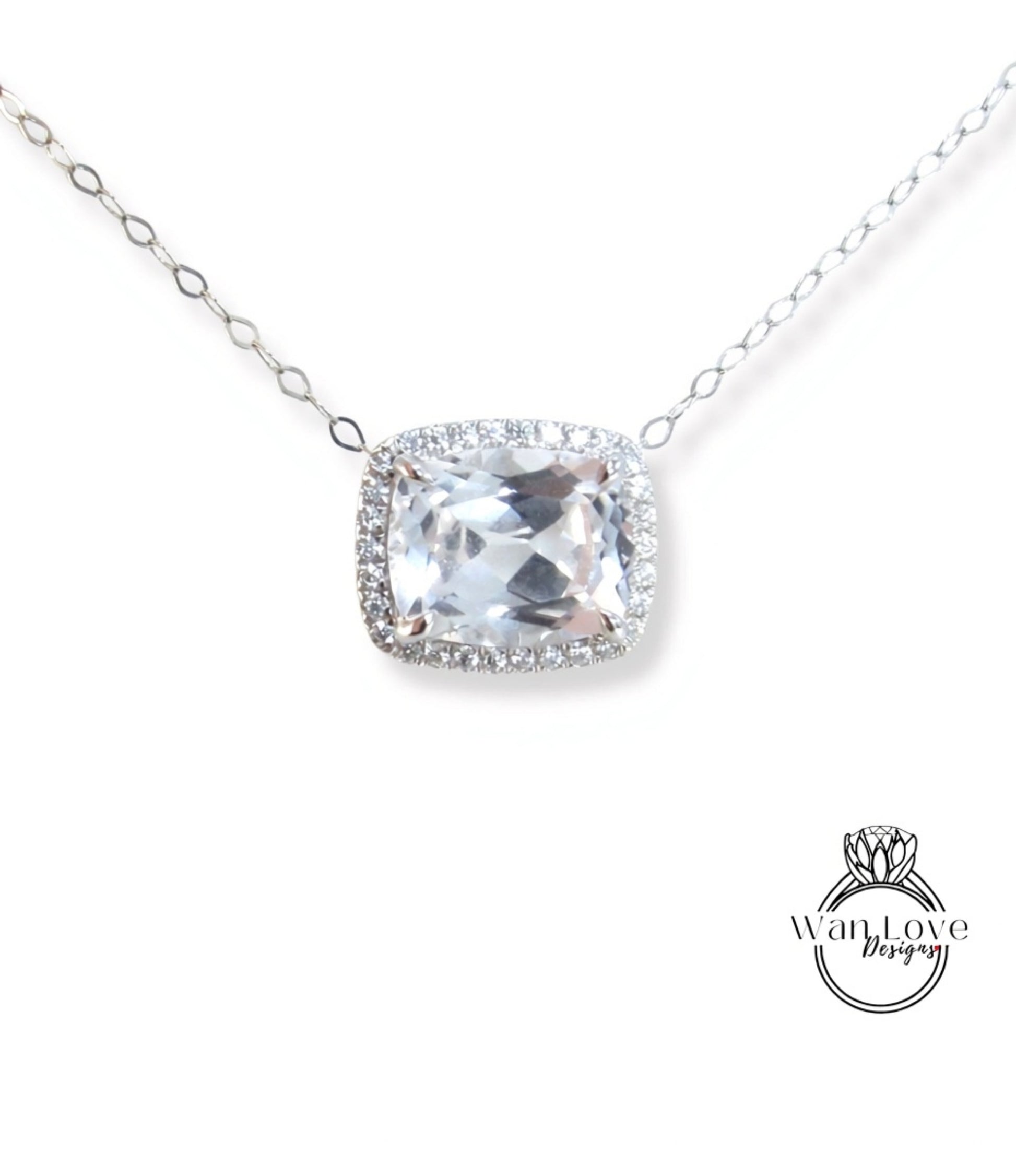 A necklace with a large, clear gemstone pendant, surrounded by a halo of smaller diamonds.