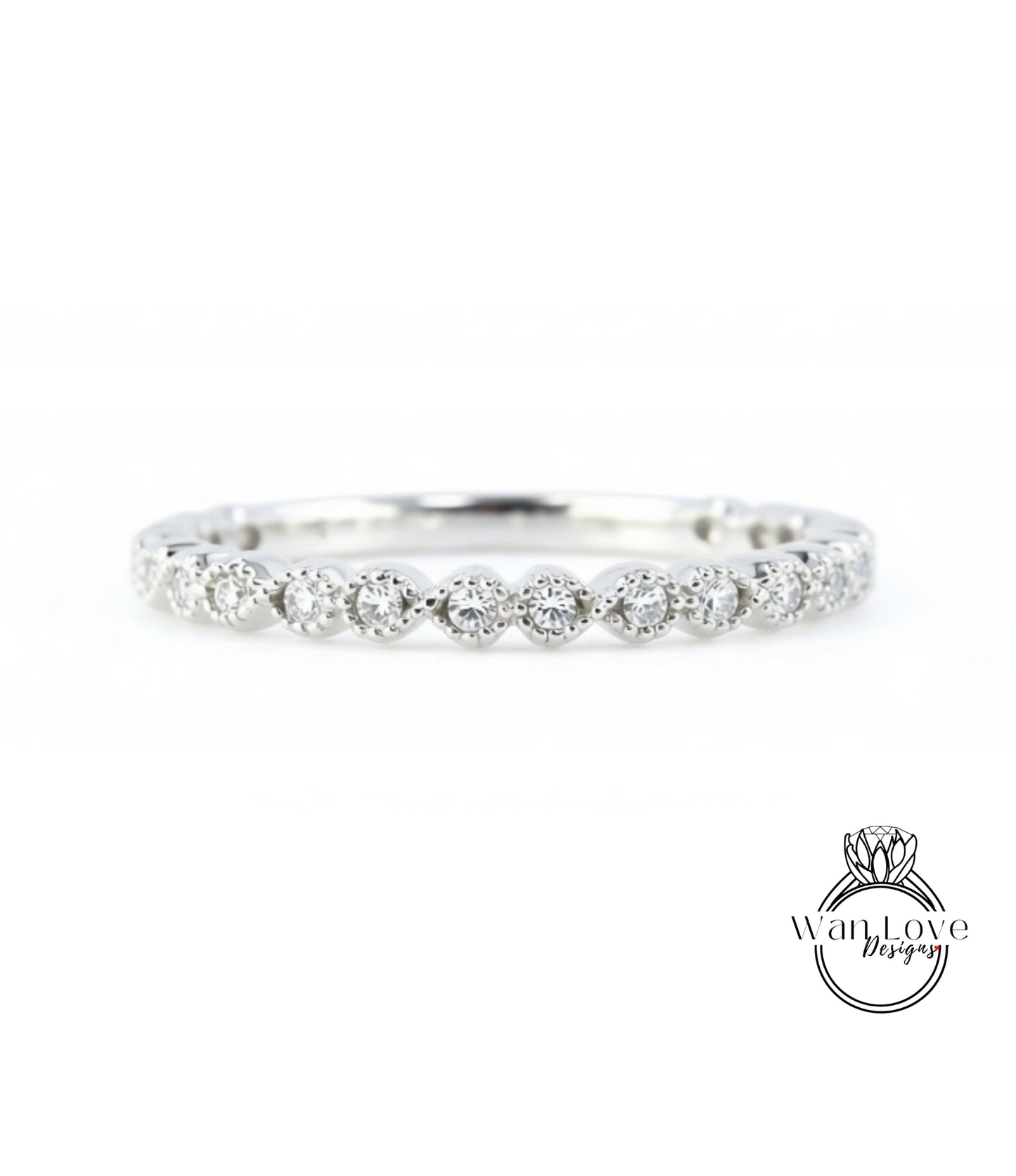 A diamond-encrusted ring with a row of small diamonds set in the center, showcasing the intricate design and craftsmanship of the piece.