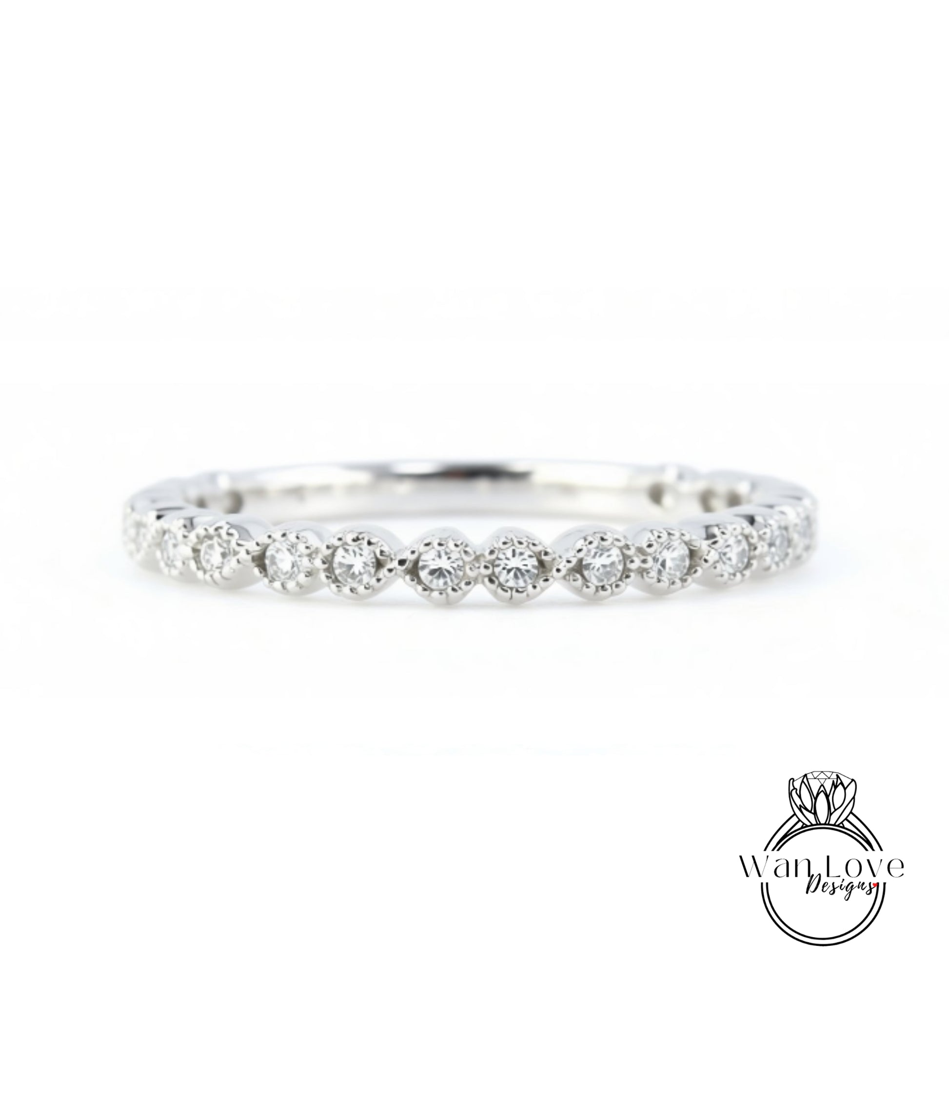 A diamond-encrusted ring with a row of small diamonds set in the center, showcasing the intricate design and craftsmanship of the piece.