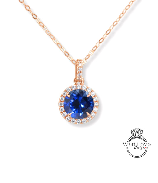 A necklace with a large blue gemstone pendant, surrounded by a halo of smaller diamonds.