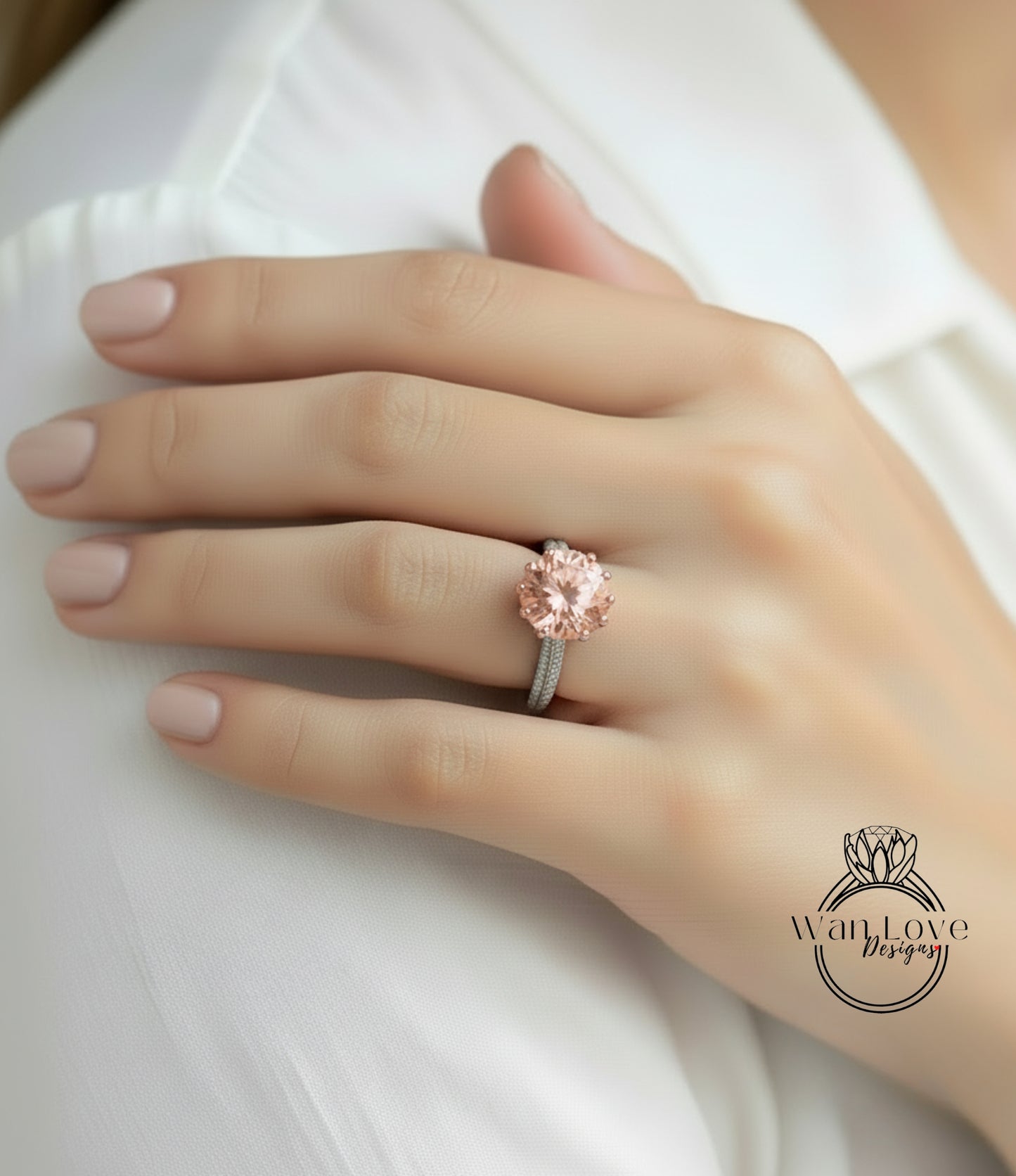 A close-up of a person's hand wearing a pink diamond engagement ring.