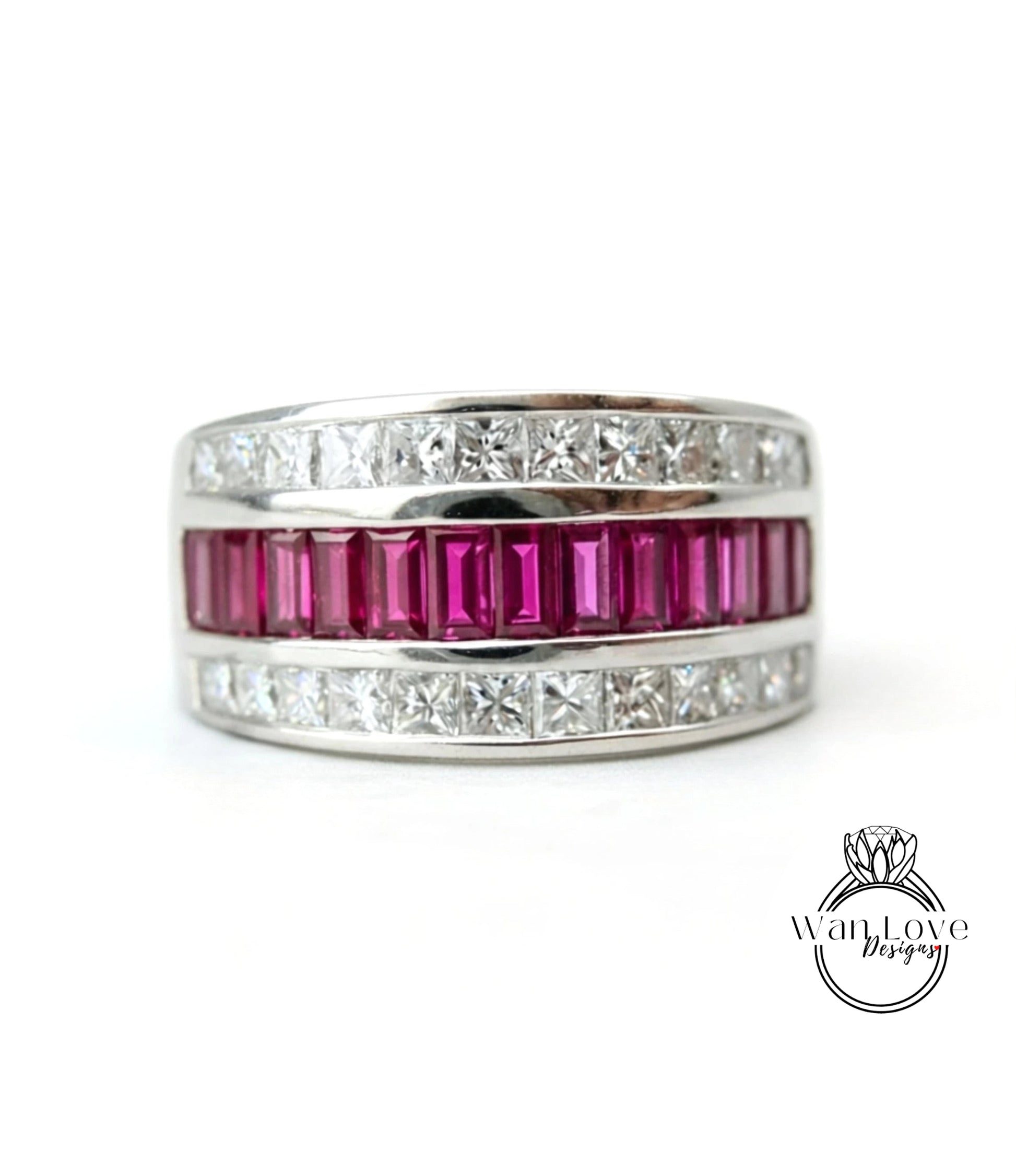 A silver ring with a row of pink gemstones, including rubies, set in a band.