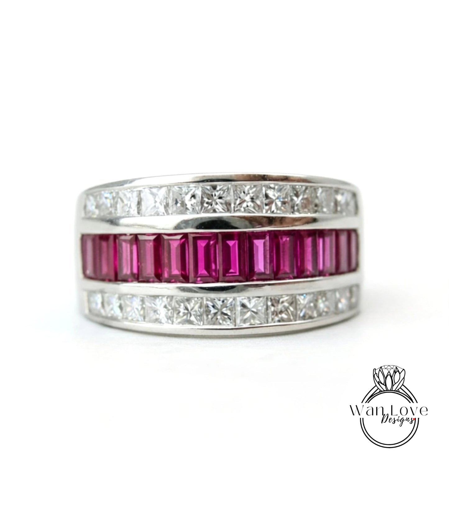 A silver ring with a row of pink gemstones, including rubies, set in a band.