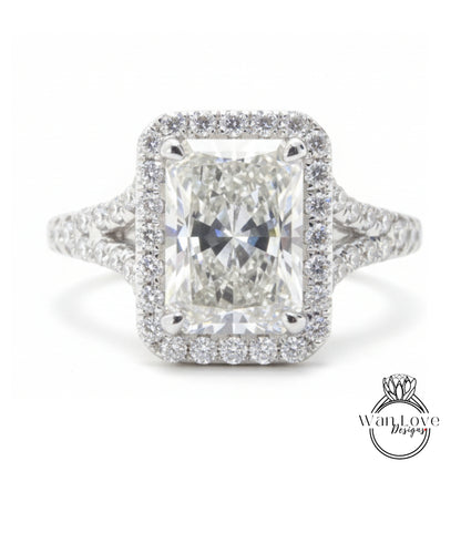 A stunning diamond engagement ring with a large central diamond surrounded by a halo of smaller diamonds set in a silver band.